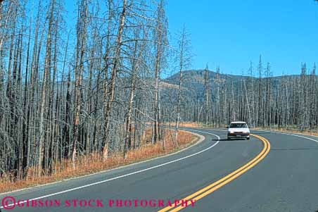 Stock Photo #11005: keywords -  burn burned burns car cars char charred damage damaged dead destroy destroyed disaster disastrous ecological ecology fire forest forestfire horz impact impacted kill killed national park parks public road roads ruined scare scared through tree trees usa wildfire wyoming yellowstone