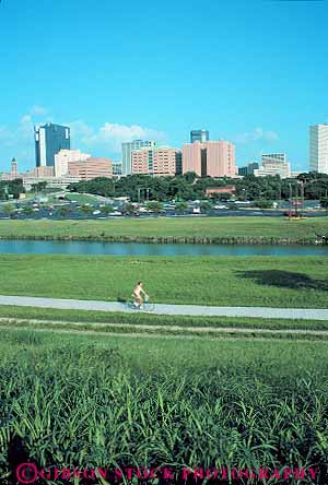 Stock Photo #13710: keywords - bicycle bicycling bicyclist bike biker biking buildings cities city cityscape cityscapes conditioning downtown exercise fitness fort ft ft. grass green health municipal open outdoor outside park parks path people person physical ride rider riders riding route skyline skylines space summer texas trail trails trinity urban vert warm woman workout worth