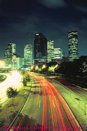 Stock Photo #7559: keywords - america american architecture blur building buildings business center cities city cityscape cityscapes dark downtown dusk evening houston light lighting lights modern motion move movement moving new night office skyline skylines streak texas traffic urban usa vert west
