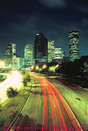 Stock Photo #7559: keywords -  america american architecture blur building buildings business center cities city cityscape cityscapes dark downtown dusk evening houston light lighting lights modern motion move movement moving new night office skyline skylines streak texas traffic urban usa vert west