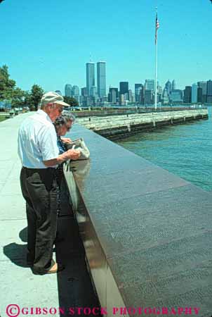 Stock Photo #9146: keywords -  american attraction city commemorate couple elderly ellis harbor historic history honor immigrants immigrate immigration island islands memorial memorials monument monuments new of people site tourist vert wall york