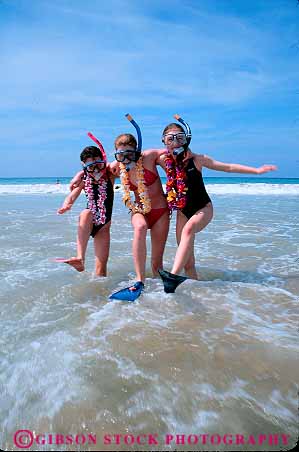 Stock Photo #13054: keywords -  beach beaches children destination girl girls hawaii hawaiian in island islands leisure oahu play playing recreation released snorkel snorkeling snorkels surf three travel tropical vacation vert waikiki water