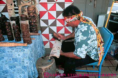 Stock Photo #13128: keywords - carve carver carves carving center craft crafts craftsman cultural demonstrate demonstrates demonstrating demonstrator demonstrators hawaii hawaiian hawaiians heritage historic history horz island islands man native natives oahu people polynesian recreate recreates recreating reenact reenacting reenactment reenacts sculpting sculptor sculpture sculptures showing tropical wood