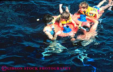Stock Photo #8652: keywords -  beach beaches big boy boys brother brothers child children coast coastal colorful destination families family float floats fun hawaii hawaiian horz island islands marine maritime ocean parent parents play released resort resorts sea seashore seawater share shore shoreline sibling snorkel snorkeling surf swim swimmers swimming swims together travel tropical usa vacation water