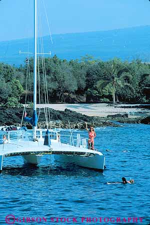 Stock Photo #13161: keywords -  big boat boats catamaran catamarans hawaii hawaiian island islands kailua kona people recreation snorkel snorkeling sport swim swimming tropical vacation vert