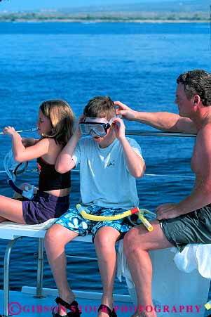 Stock Photo #13164: keywords -  big boat children equipment family father hawaii hawaiian island islands kailua kona parent puts recreation snorkel snorkeler snorkelers snorkeling sport trip tropical vacation vert