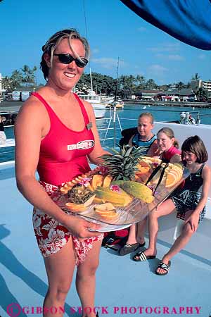 Stock Photo #13165: keywords -  big boat boats eat eating food fruit hawaii hawaiian island islands kailua kona passenger passengers recreation server serves snack sport tour tours tropical vacation vert woman