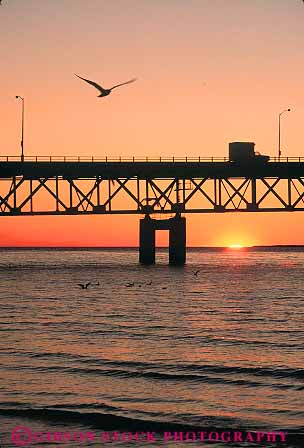 Stock Photo #13196: keywords -  behind bridge bridges dark dawn dusk evening great lakes mackinac michigan midwest orange region sunrise sunset sunsets truck trucking trucks vert water