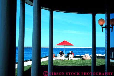 Stock Photo #3567: keywords - calm carriage cocktail couple horz house island mackinac michigan outdoor patio private relax social solitude talk travel umbrella waiter