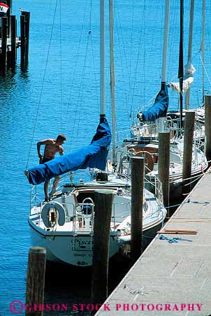 Stock Photo #13254: keywords - bay boats dock docks great lakes man men michigan recreation region sailboat sailboats sailing sailor summer traverse vacation vert wharf