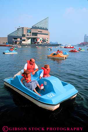 Stock Photo #11159: keywords -  baltimore boat boating child children colorful dad families family father fiberglass float floats fun harbor harbors inner man maryland material parent peddle plastic play playing recreation rent single summer synthetic toy toys vert water