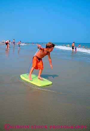 Stock Photo #12354: keywords - beach beaches boarding boy boys child childen chincoteague families family in island kid kids look looking ocean play playing plays pointing recreation sea summer surf trail vacation vert virginia warm