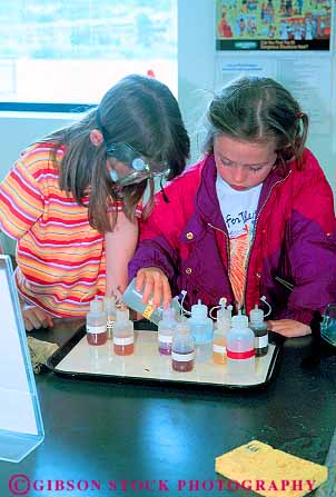 Stock Photo #11251: keywords -  adolescents and chemistry child children curious educate education educational equipment experience experiment experiments explore friend friends gear girl girls glasses industry kid kids learn learning museum of oregon pair people perform portland protection protective science student students team test testing together two vert youth