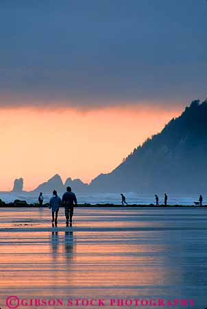 Stock Photo #13404: keywords -  beach cannon cloud clouds cloudy coast coastal couple couples dark dusk evening landscape landscapes mood moody northwest ocean oregon outdoor outside people resort sand scenery scenic scenics sea shore shoreline shorelines strolling summer sunset sunsets vert water