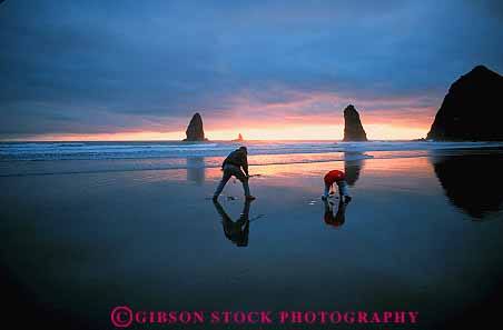 Stock Photo #13406: keywords -  beach bright calm cannon child children coast coastal dark dusk evening horz in kid kids landscape landscapes mood moody northwest ocean oregon people pink play playing plays reflect reflecting reflection reflects resort sand scenery scenic scenics sea shore shoreline shorelines smooth summer sunset sunsets water wet