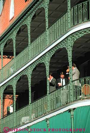 Stock Photo #8550: keywords -  architecture balconies balcony building buildings business decorate decorated decorative design destination detail elevate elevated french group ironwork ironworks louisiana man men new orleans quarter recreation travel usa vacation vert