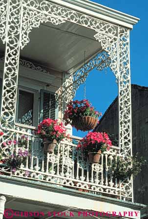 Stock Photo #8552: keywords -  architecture balconies balcony building buildings decorate decorated decorative design destination detail elevate elevated french hanging iron ironwork ironworks louisiana new orleans paint painted petunia petunias plants porch quarter recreation travel usa vacation vert white