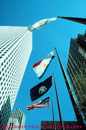 Stock Photo #8597: keywords -  between building buildings downtown flag flags high louisiana new office orleans poles rise sky up upward urban vert view