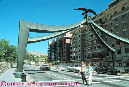 Stock Photo #9648: keywords -  arch arches cities city couple cross downtown eagle gate horz lake metal pedestrians people salt sculpture sculptures street streets urban utah walk walking