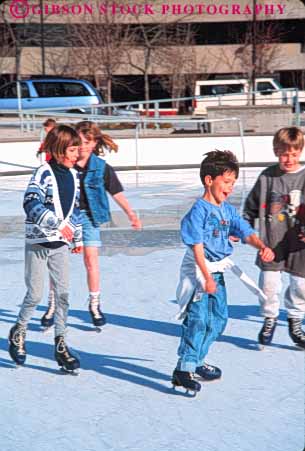 Stock Photo #9666: keywords -  balance balanced balancing boy boys center child children city exercise exercising freeze freezing froze frozen fun gallivan gender girl girls glide gliding group groups ice icy lake mixed play playing recreation rink rinks salt skate skater skates skating slide sliding slippery sport sports utah vert winter youth