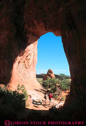 Stock Photo #13631: keywords -  arch arches circle circular couple couples exposure formation formations geologic geological geology hike hiker hikers hikes hiking hole landscape landscapes national opening pair park parks people pine public recreation red redrock round sandstone scenery scenic sedimentary slickrock tree tunnel utah vert