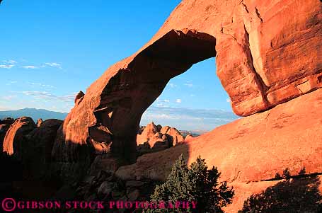 Stock Photo #13638: keywords - arch arches circle circular dawn exposure formation formations geologic geological geology hole horz landscape landscapes national opening park parks public red redrock round sandstone scenery scenic sedimentary skyline slickrock tunnel utah