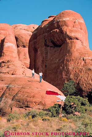 Stock Photo #13639: keywords -  arches climb couple couples exposure formation formations geologic geological geology hiker hikers hikes landscape landscapes national outdoor outside park parks people public recreation red redrock rocks sandstone scenery scenic sedimentary slickrock utah vacation vert walk walking