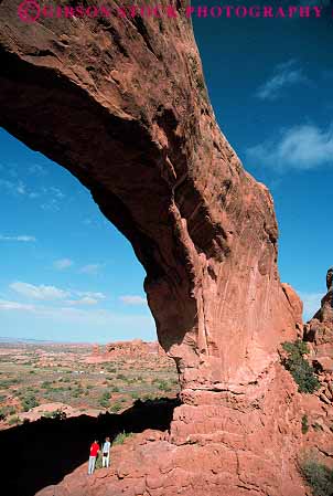 Stock Photo #13641: keywords -  arch arches big climb couples exposure formation formations geologic geological geology high hiker hikers hikes hiking huge landscape landscapes large national north outdoor outside park parks people public recreation red redrock sandstone scenery scenic sedimentary slickrock tall utah vacation vert walk walking window