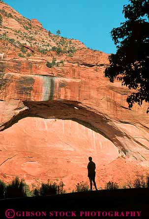 Stock Photo #12004: keywords -  against arch arches canyon canyons cliff cliffs ecology environment geologic geological geology habitat in landscape landscapes mountains national park parks preserve public red rock sandstone scenery scenic silhouette silhouettes utah vert woman zion