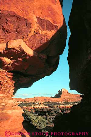 Stock Photo #13649: keywords -  canyonlands exposure formation formations gap geologic geological geology hole holes landscape landscapes national natural nature opening park parks public red redrock rock rocks sandstone scenery scenic sedimentary slickrock slot slots tunnel tunnels utah vert view