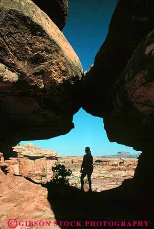 Stock Photo #13651: keywords -  canyonlands exposure formation formations gap geologic geological geology hike hiker hikers hikes hiking hole in landscape landscapes national natural nature opening park parks people person public recreation red redrock released sandstone scenery scenic sedimentary silhouette slickrock slot tunnel utah vert woman