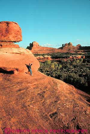 Stock Photo #13652: keywords -  alone canyonlands exposure formation formations geologic geological geology landscape landscapes national natural nature park parks people person private public red redrock relax relaxes relaxing released sandstone scenery scenic sedimentary slickrock solitary solitude stand standing stands sunset utah vert woman