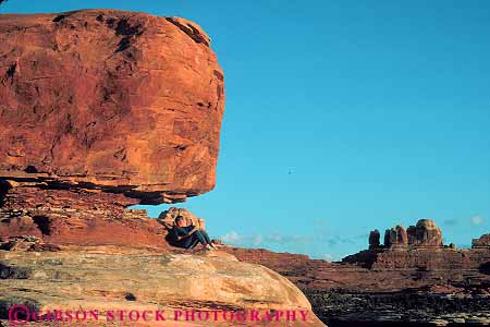 Stock Photo #13653: keywords -  alone canyonlands exposure formation formations geologic geological geology horz landscape landscapes national natural nature park parks people person private public red redrock relax relaxes relaxing released sandstone scenery scenic sedimentary sit sits sitting slickrock solitary solitude sunset utah woman