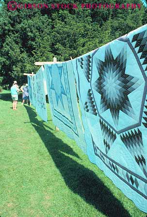 Stock Photo #14185: keywords -  amish attraction blanket country display displaying displays dutch fabric for hand handcrafted handicraft handicrafts handmade hanging heritage lancaster line made merchandise outdoor outside pennsylvania quilt quilts retail sale sales selling sells tourist traveler vert