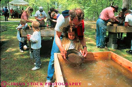 Stock Photo #11599: keywords -  [playing activity american amusement annual antebellum atlanta attraction civil costume costumed dad daughter event fair fairs father festival festivals for fun georgia girl gold history horz living man mountain outdoor outside pair pan panning park parks people play portray portrays recreation reenact reenacting reenactment reenacts south stone team together tourist two war