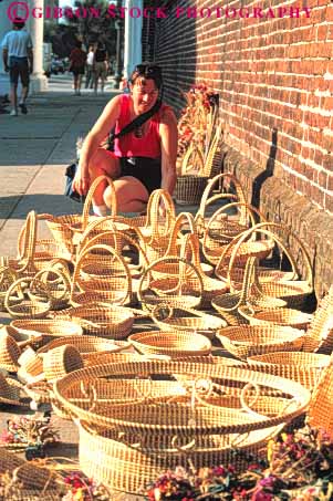 Stock Photo #9630: keywords -  array basket baskets business carolina charleston collection craft crafts destination display examines hand handmade made merchandise outdoor outside released retail sell seller selling small south straw street tourist travel vendor vendors vert woman