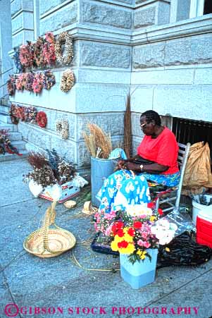 Stock Photo #9631: keywords -  african american basket black business carolina charleston craft crafts craftsman craftswoman destination display ethnic female flower hand handmade made makes merchandise minority outdoor outside retail sell seller selling sidewalk small south street travel vendor vendors vert woman wreath wreaths