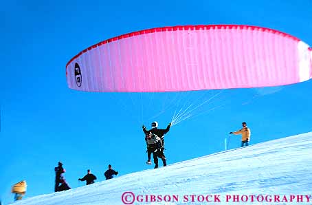 Stock Photo #14885: keywords -  baldi color colorful communities community destination float floating floats fly flyer flyers flying glide glider glides gliding horz idaho lift lifting liftoff lifts material mount mountain mountains mt mt. nylon paraglidder paraglidders paraglidding people recreation red region resort resorts ride rider rides riding rocky ski snow sport sun synthetic thrill thrilling thrills travel vacation valley winter