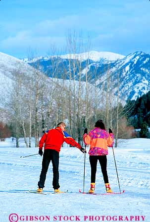 Stock Photo #14890: keywords -  bright clothing communities community country couple cross crosscountry destination idaho man mountain mountains nordic pair people recreation red region resort resorts rocky ski skiers skiing slier snow sun travel two vacation valley vert winter woman