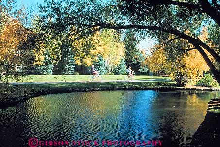 Stock Photo #14896: keywords -  along autumn bicycling bicyclist bicyclists bikers bikes color communities community couple destination fall foliage horz idaho landscape mountain mountains people person pond recreation region resort resorts rocky scenery scenic season sun travel vacation valley