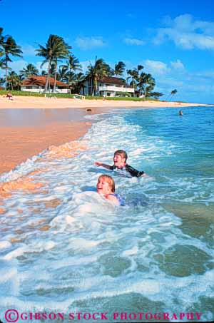 Stock Photo #8696: keywords -  beach beaches coast coastal destination fun girls hawaii hawaiian in island islands kauai laugh marine maritime ocean play playing poipu released resort resorts sand sea seashore seawater shore shoreline smile smiles surf swim swimmers swimming travel tropical usa vacation vert water