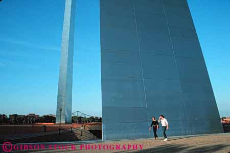 Stock Photo #7759: keywords - america american arch arches architecture building buildings center cities city couple curve dark dusk evening gateway graceful horz louis memorial metal missouri modern people saint st st. steel tall urban usa walk walking