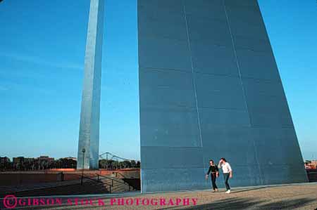 Stock Photo #7759: keywords -  america american arch arches architecture building buildings center cities city couple curve dark dusk evening gateway graceful horz louis memorial metal missouri modern people saint st st. steel tall urban usa walk walking