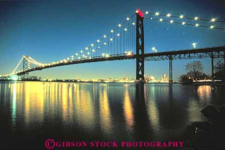 Stock Photo #11011: keywords - across ambassador angle angles bridge bridges connect connected connecting connects cross crosses dark detroit dusk engineer engineered engineering evening geometric geometrical geometry horz lighting lights michigan night over reach reaches reaching reflect reflecting reflection reflects rigid rigidity river rivers span spanning spans structure support supports suspension transportation