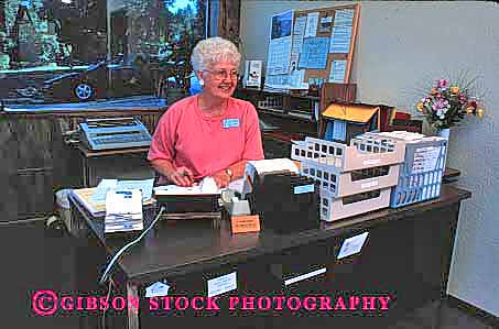 Stock Photo #1251: keywords -  business commerce corporate elderly female grandma gray hair happy horz in income job mature occupation office old older paycheck people person receptionist released senior seniors smile volunteer woman works