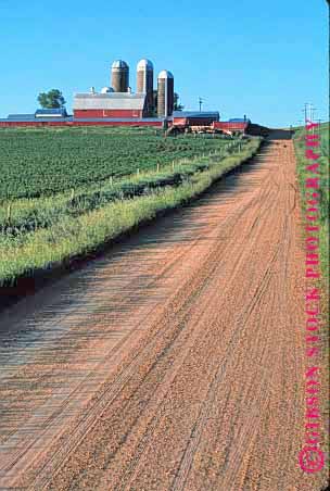 Stock Photo #1260: keywords -  agriculture buidings building countryside dairy dirt elevator farm fence grain green illinois landscape lush not ranch released road roads rural scenery scenic silo silos street vert