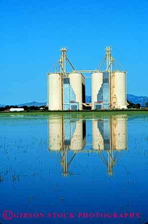 Stock Photo #6029: keywords -  agriculture blue buildings clean clear crop crops farm grow marysville plant pond reflect rice silo silos symmetry vert water