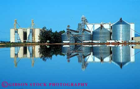 Stock Photo #6028: keywords -  agriculture blue buildings clean clear crop crops farm grow horz marysville plant pond reflect rice silo silos symmetry water