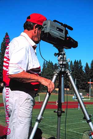 Stock Photo #1309: keywords -  cameraman communications coverage equipment event film information man media men network news outdoors outside people person playback record recording records reporting sports tape technology television tripod vert video videographer work worker working works