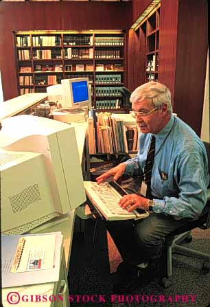 Stock Photo #6080: keywords -  book building career computer interior job learn librarian library male man new occupation of read reading released research researcher researching richmond stacks study vert virginia vocation work worker